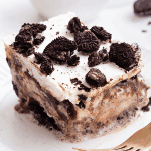 A slice of Oreo ice cream cake on a plate.