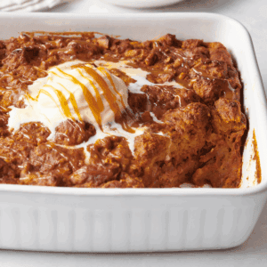Pumpkin bread pudding topped with vanilla ice cream and caramel sauce.