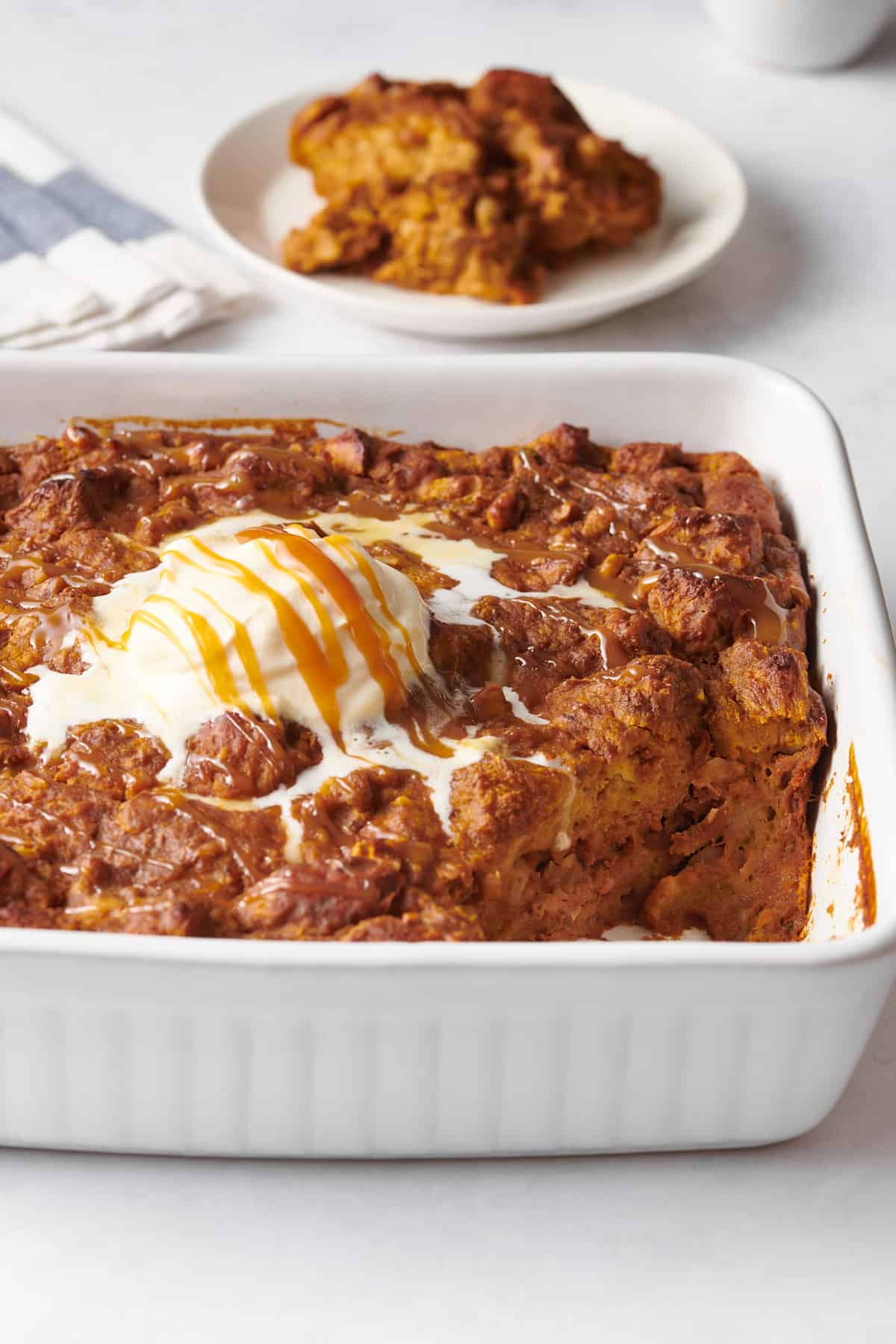 close up image of pumpkin bread pudding in a 8x8 baking dish