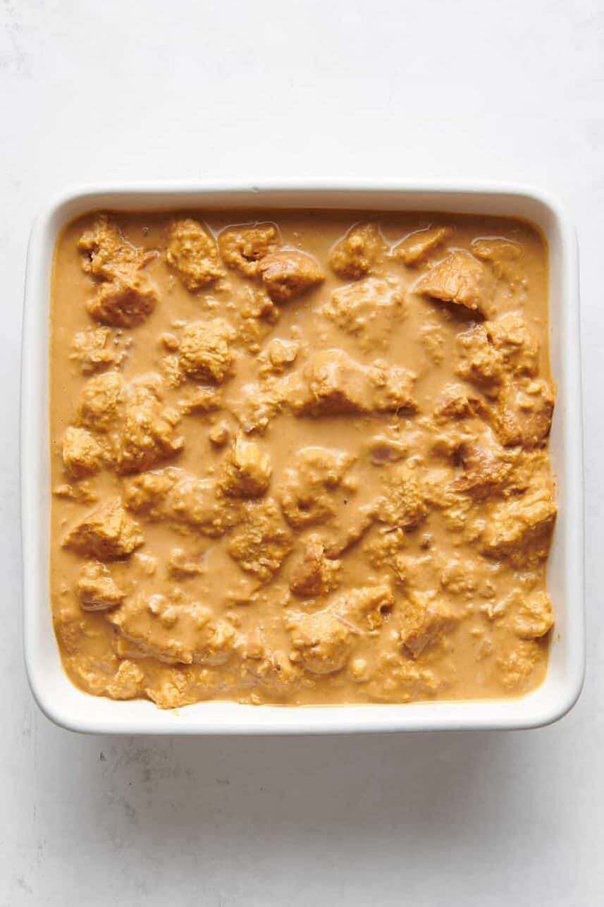 pumpkin bread pudding mixture sitting in an 8x8 baking dish