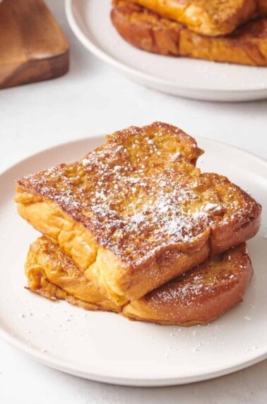 Two slices of eggnog French toast on a plate.