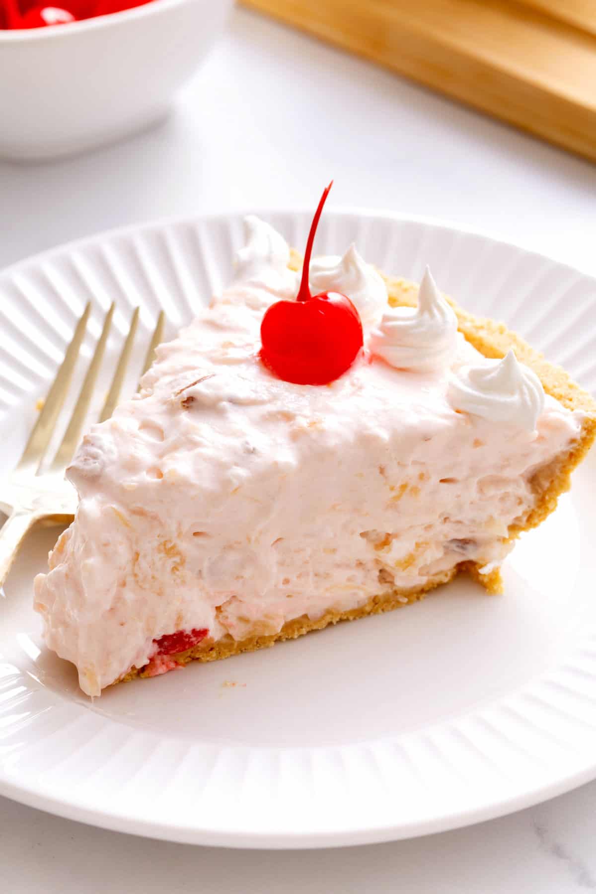 slice of millionnaires pie served on a white round plate