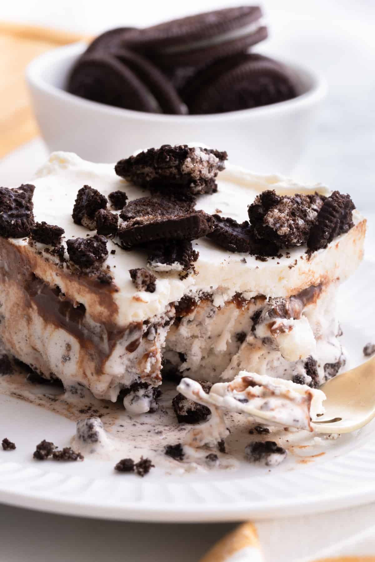 cross section slice of oreo ice cream cake served on a white round plate