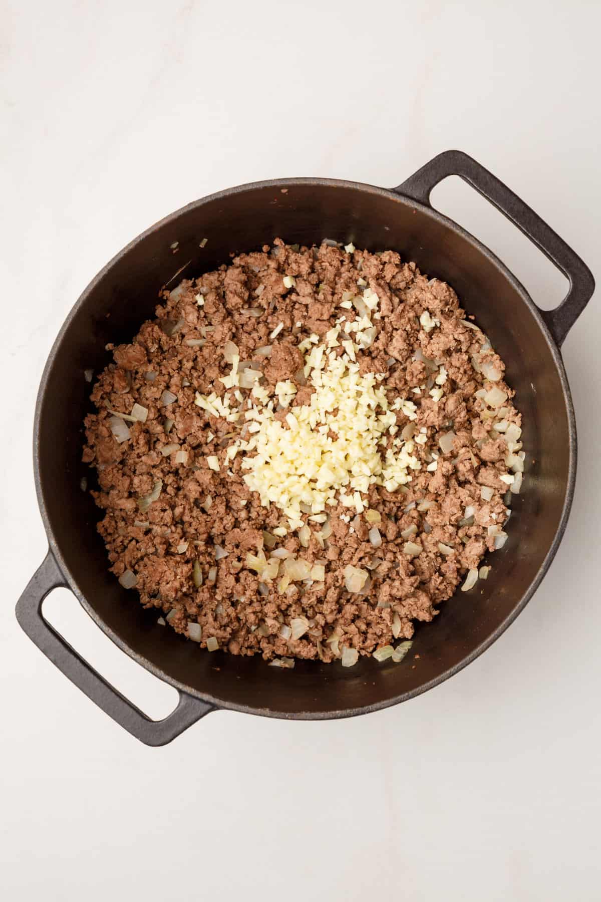 cooked ground beef, onion and garlic, in a large cast iron dutch oven