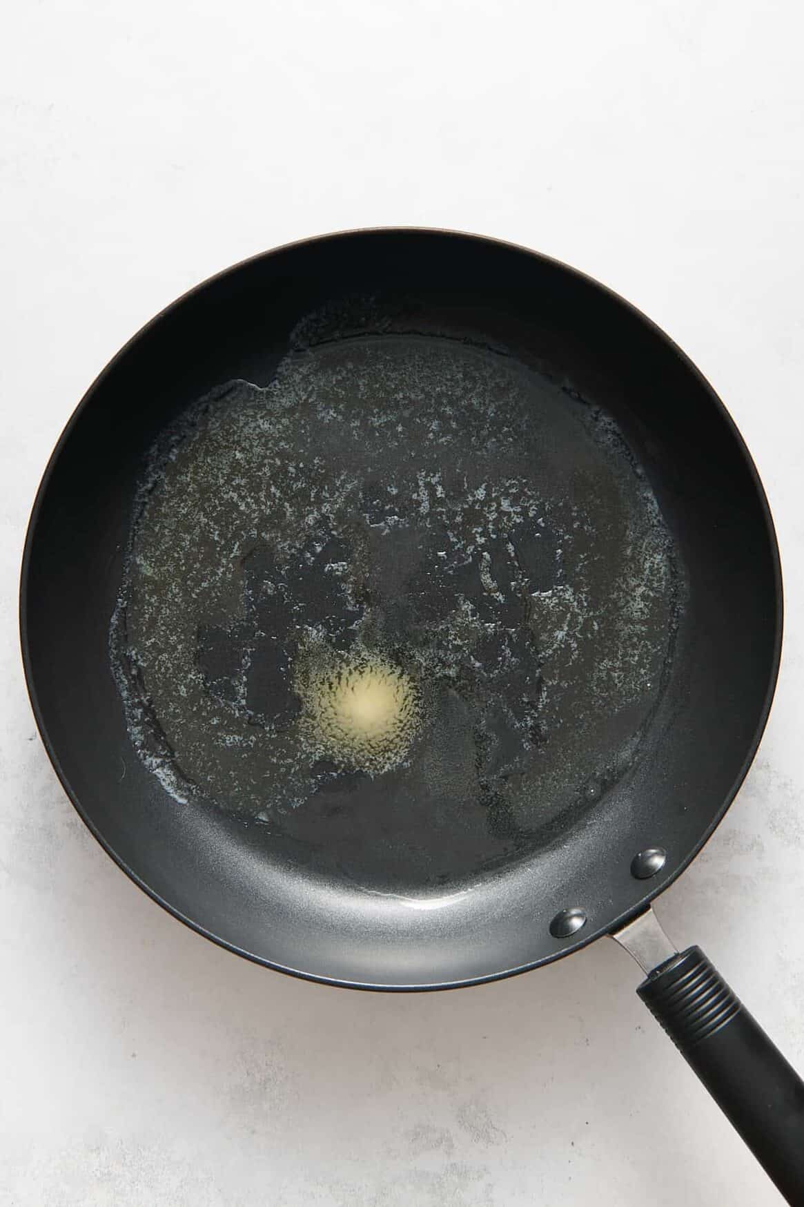 large skillet with melted butter.