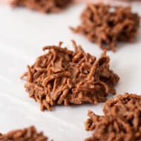 Chocolate peanut butter haystack cookies on parchment paper.