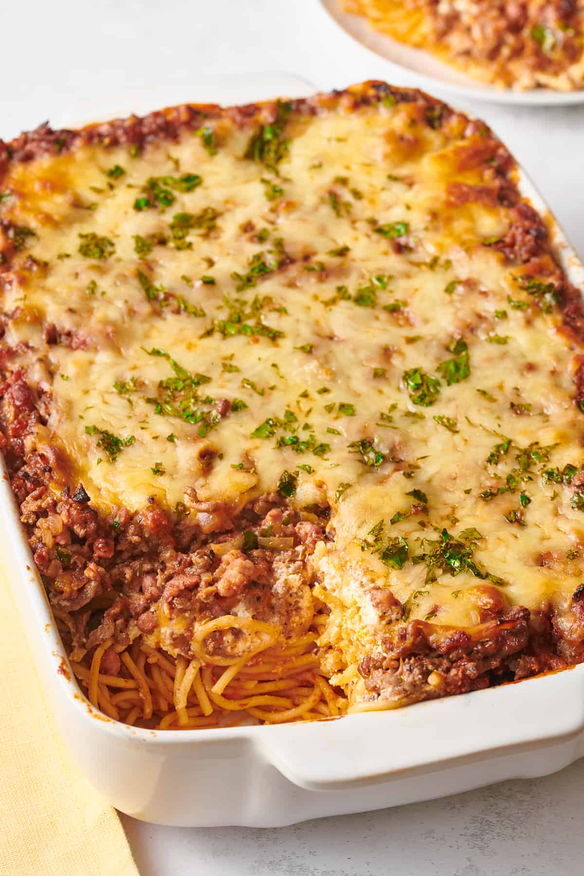 close up image of a 9x13 casserole dish of million dollar spaghetti