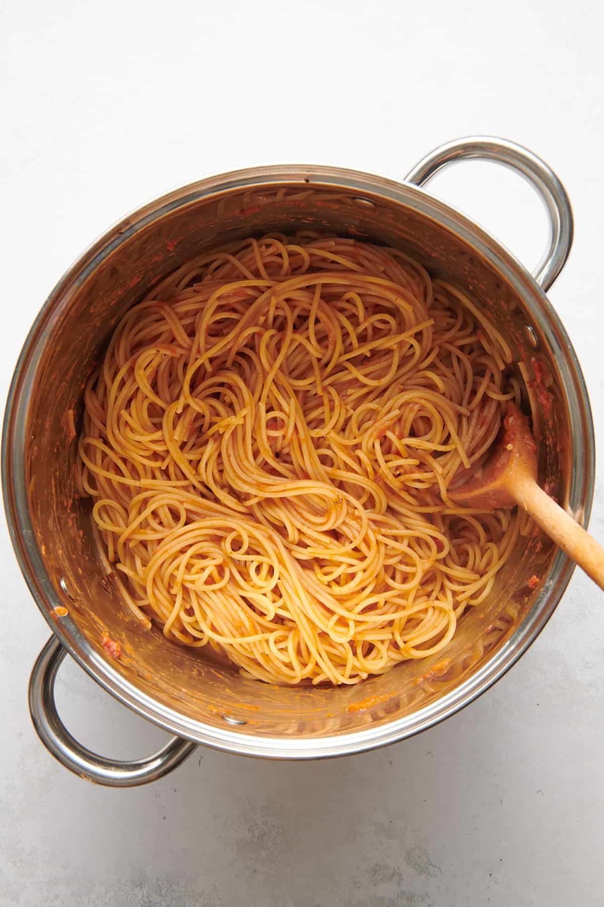 large pot of cooked spaghetti noodles with marinara sauce