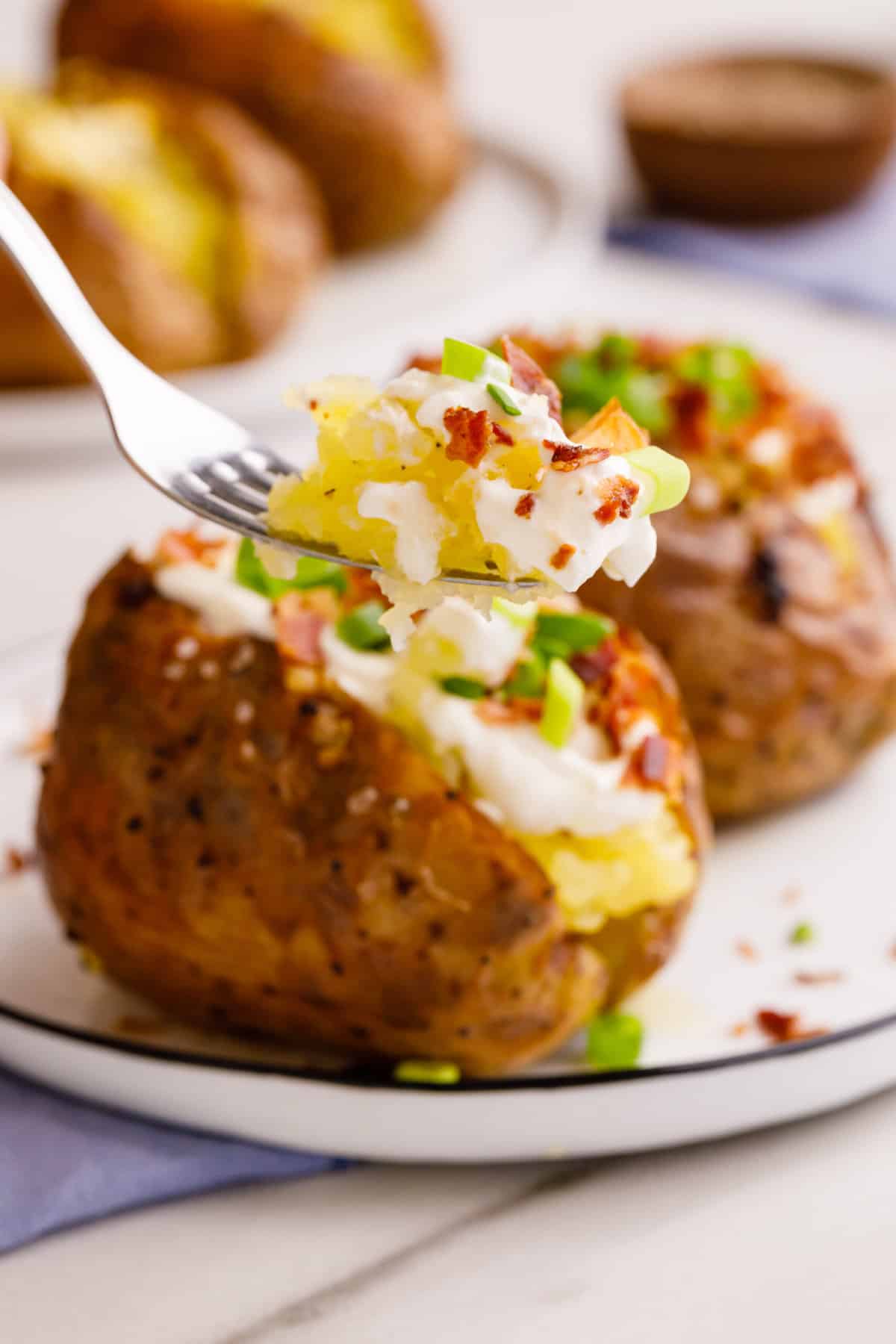 close up image of a forkful of loaded potato.