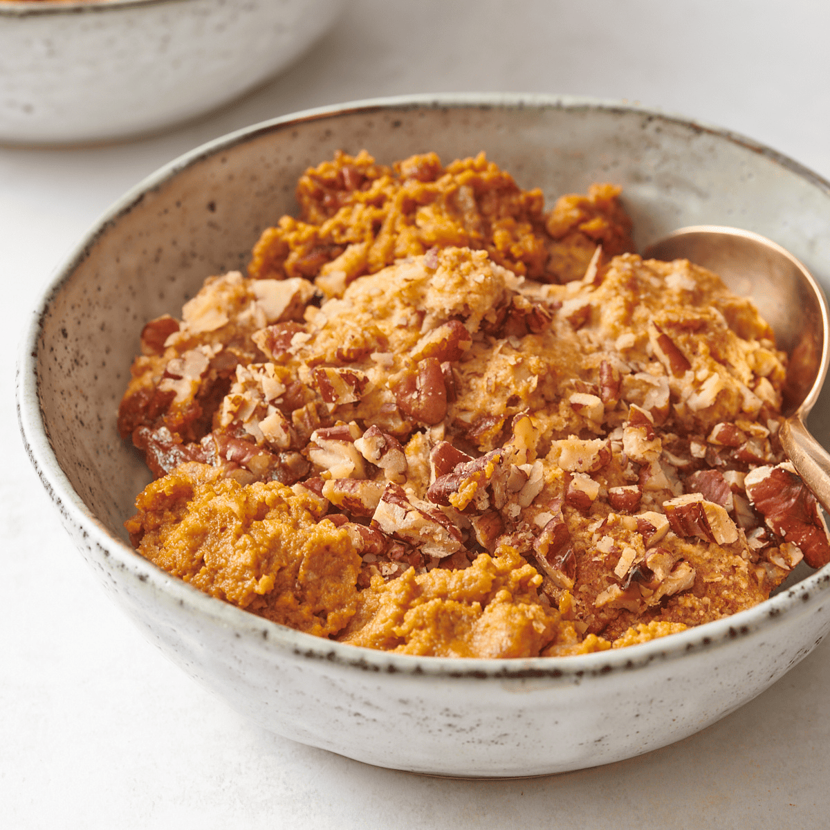 A bowl of pumpkin cobbler.