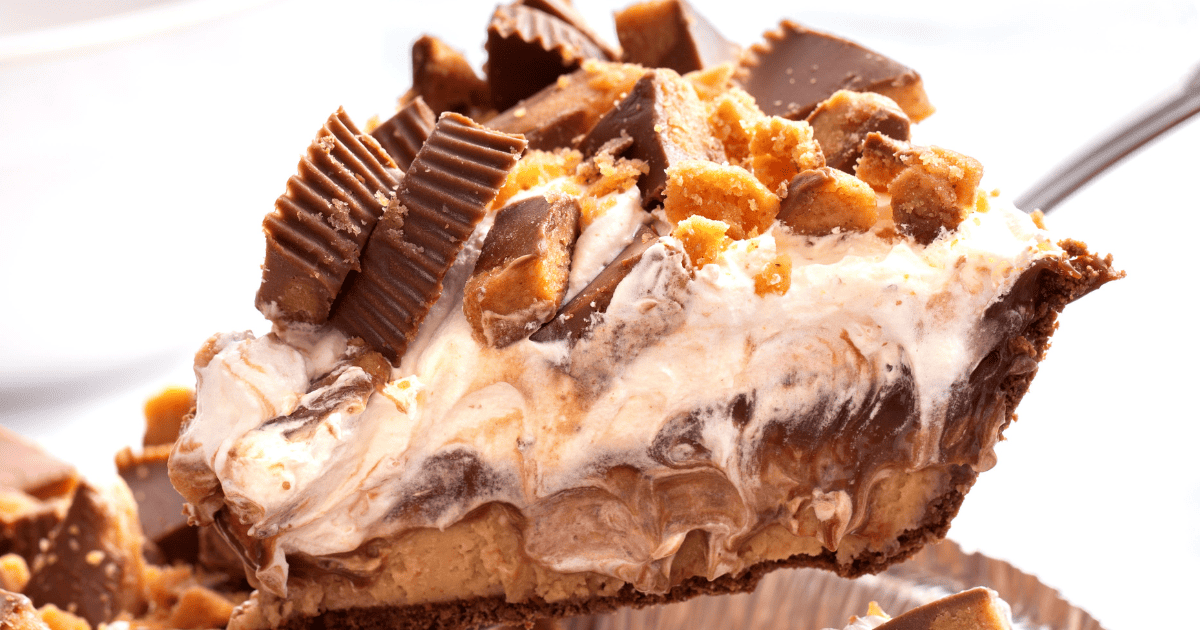 A slice of chocolate peanut butter pie being lifted from the pan. 