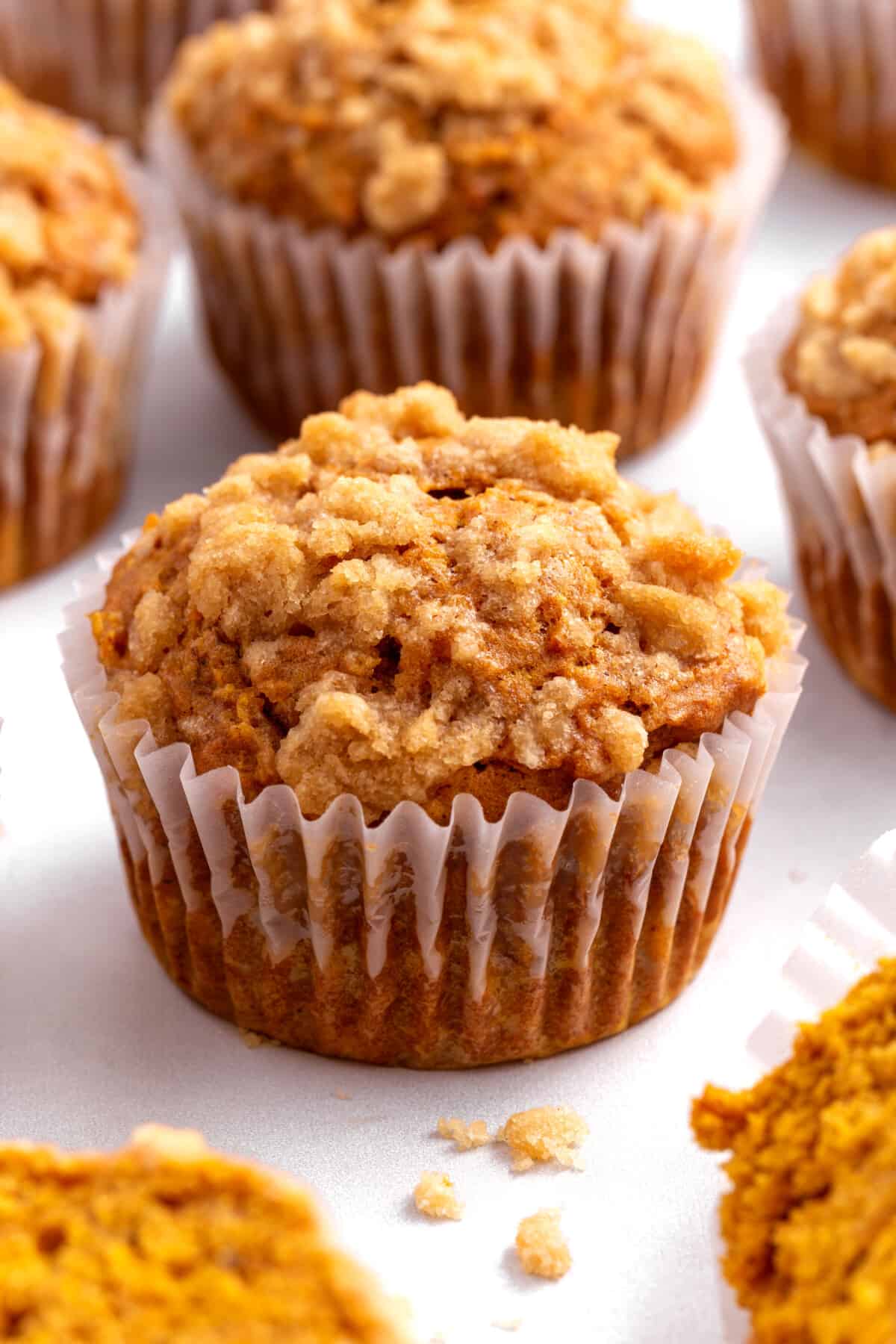A pumpkin apple muffin in a paper liner.