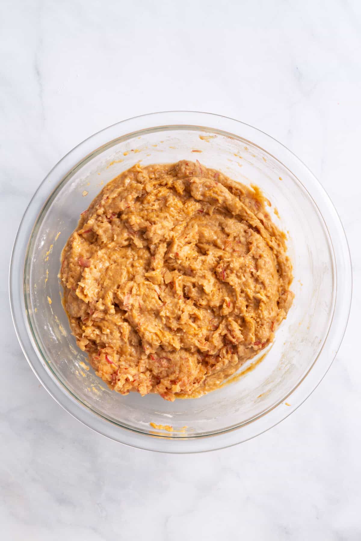 pumpkin apple muffin batter in a large glass bowl.