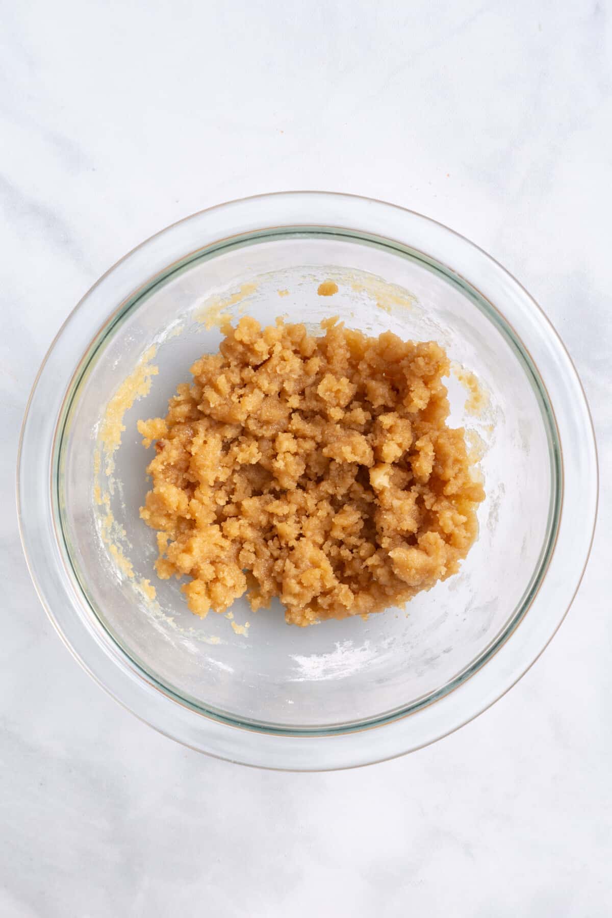 pumpkin apple muffin crumble topping mixture in a large glass bowl.