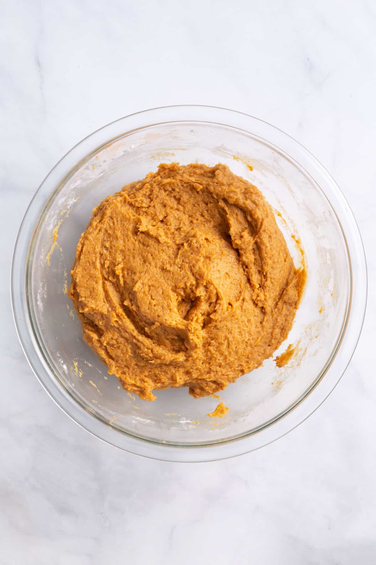 pumpkin muffin batter in a large glass bowl.