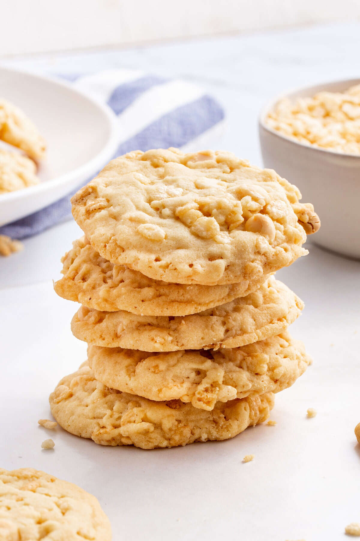 stack of five rice krispies cookies sitting on a white kitchen countertop. 