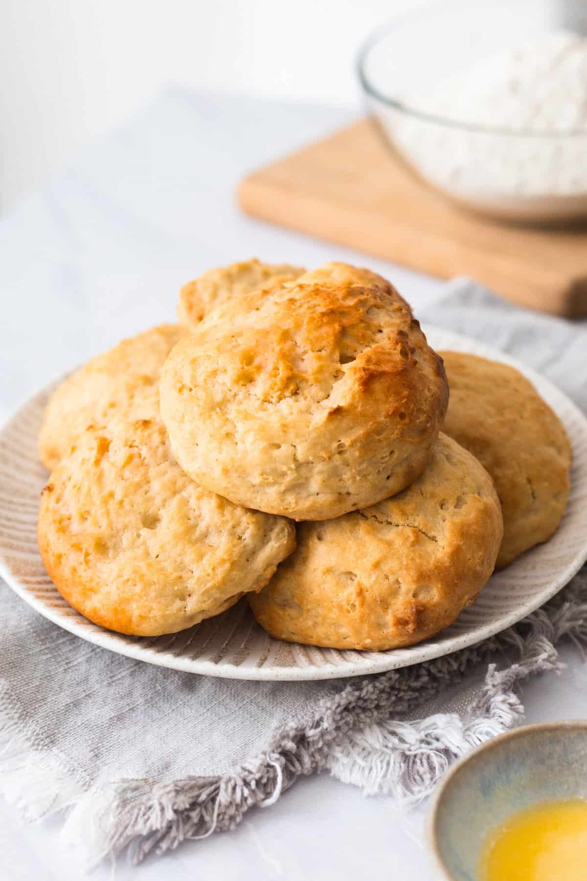 pile of easy drop biscuits sitting on a decorative white round plate.