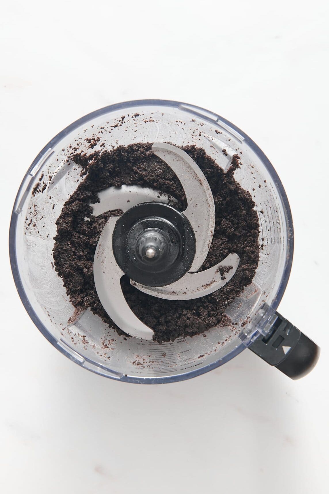 top down image of Oreo crumbs sitting in a food processor. 