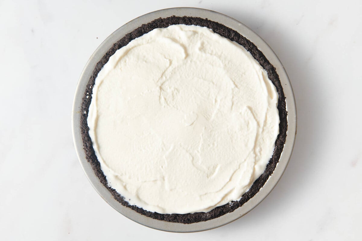 Ice cream spread into Oreo crust.