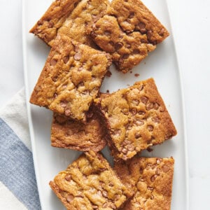Toll house chocolate chip cookie bars on a plate.
