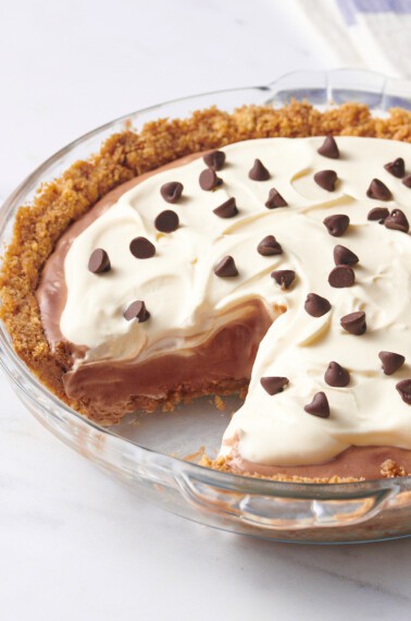 Chocolate pudding pie with a slice missing.