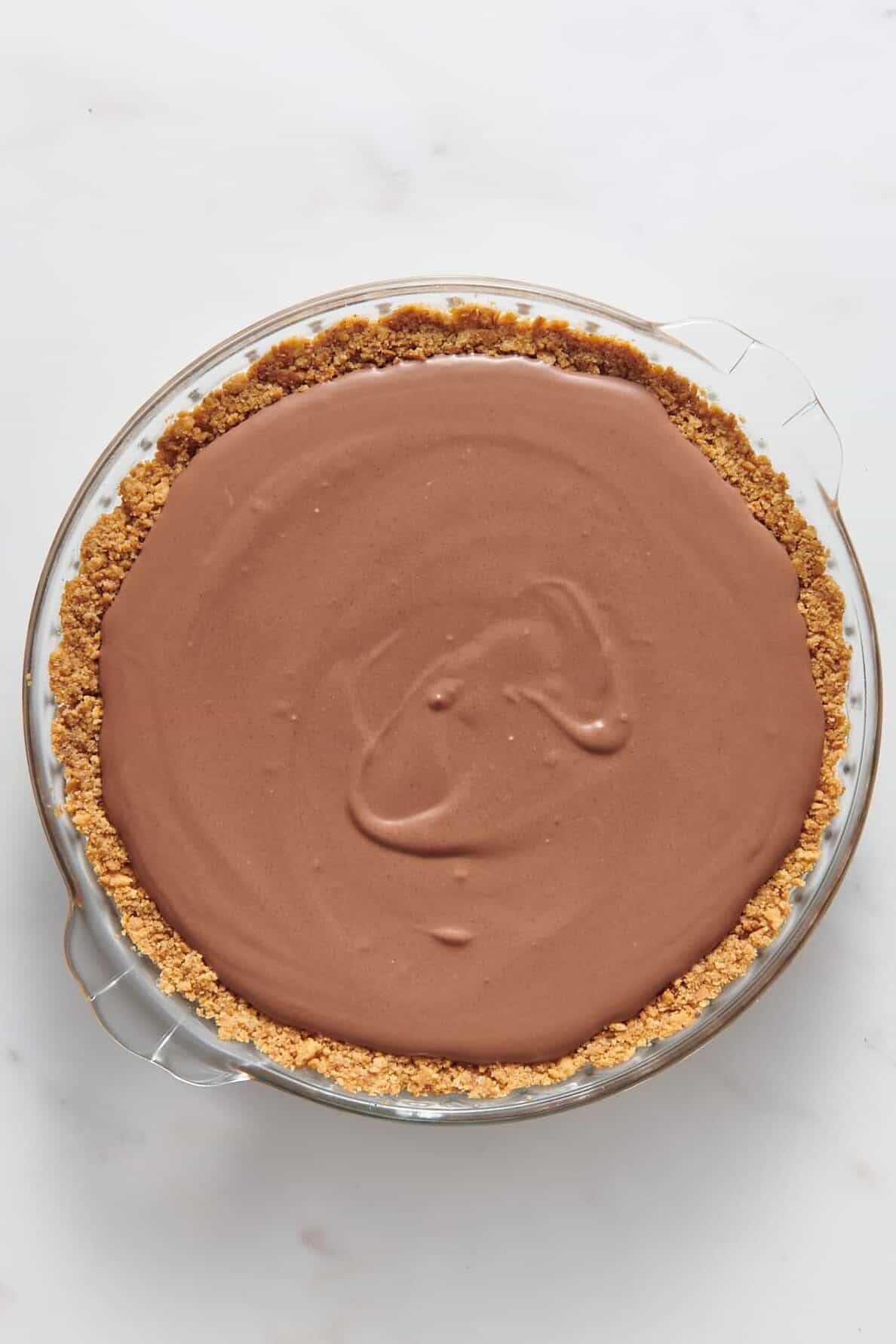 chocolate pudding filling pour into a graham cracker crust prepared pie dish.