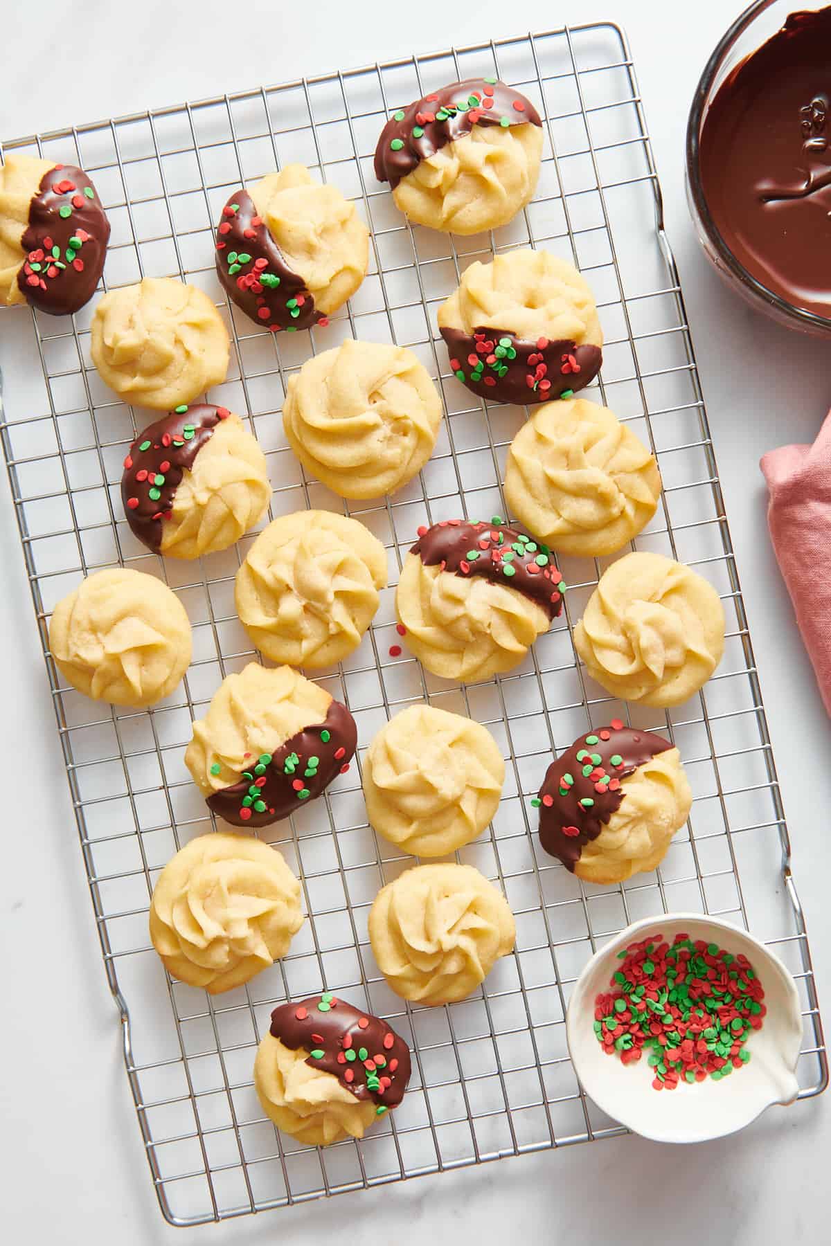 top image of christmas butter cookies sitting on a wire cooling rack.