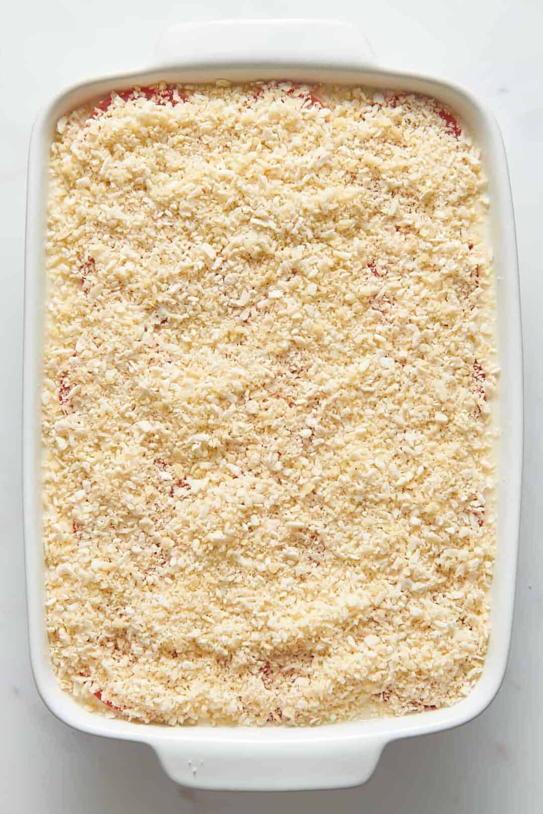 ina mac and cheese topped with panko breadcrumbs ready to be baked.