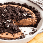 Chocolate Oreo dirt pie with a slice missing.