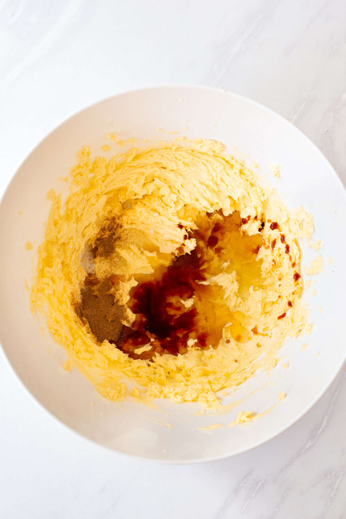 softened butter and sugar combined in a white large bowl.