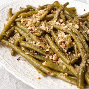 A platter of Instant Pot green beans topped with crushed almonds.