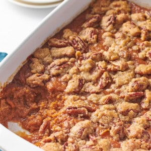 Sweet potato souffle in a casserole dish with a portion missing.