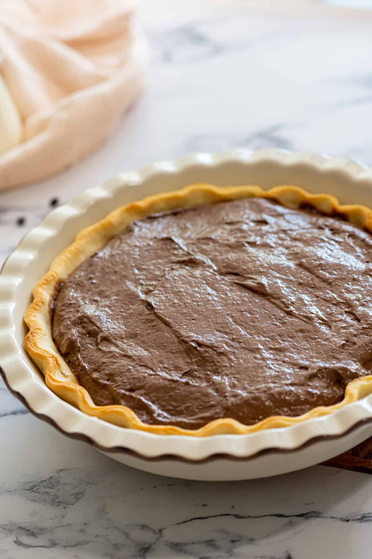 chocolate pudding cream pie filling in a baked pie crust. 