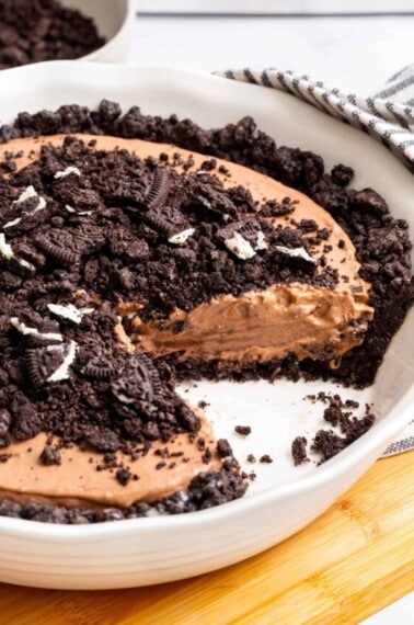 Oreo dirt pie with a slice missing.
