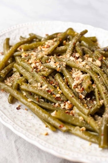 A platter of Instant Pot green beans topped with crushed almonds.