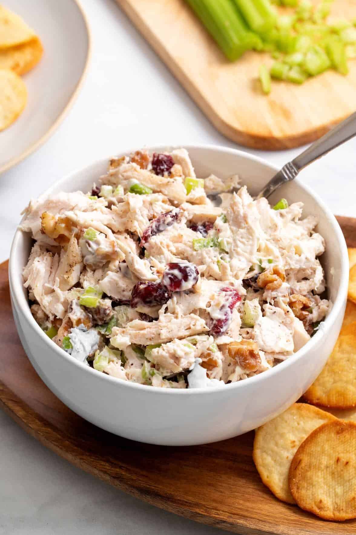 cranberry chicken salad served in a white round bowl. 