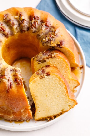 Cake mix rum bundt cake with two pieces sliced.