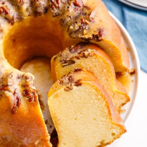 Cake mix rum bundt cake with two pieces sliced.