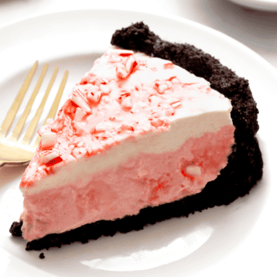 A slice of no bake candy cane pie on a plate.