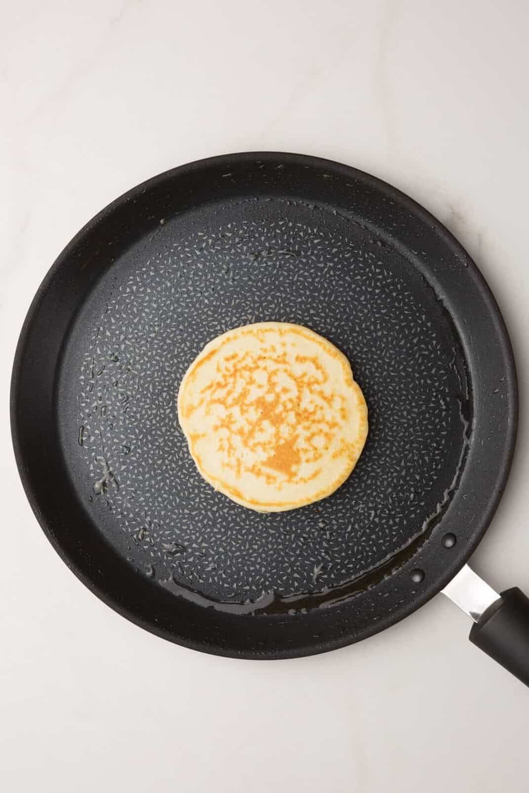 large skilled with a cooked bisquick pancake.