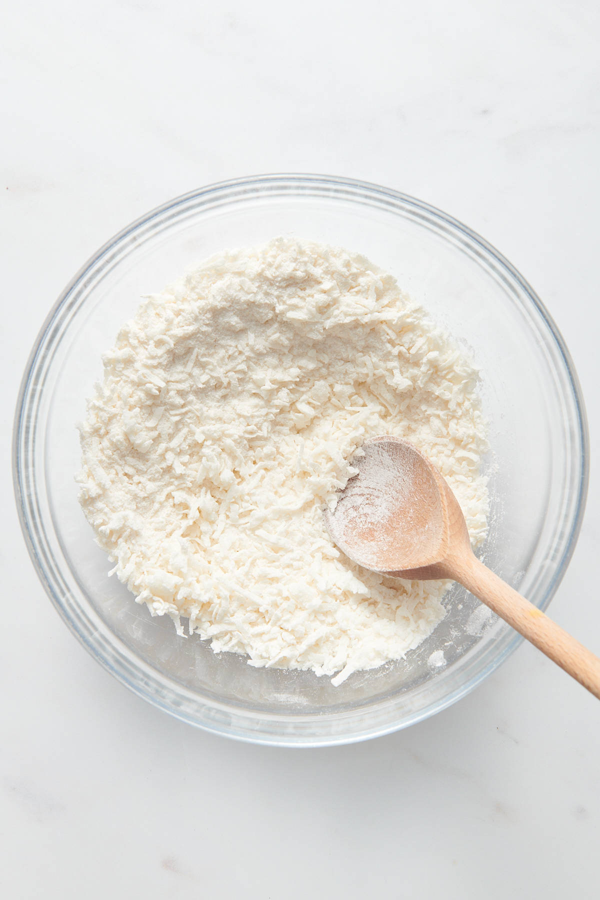 coconut shreds in a large glass mixing bowl. 