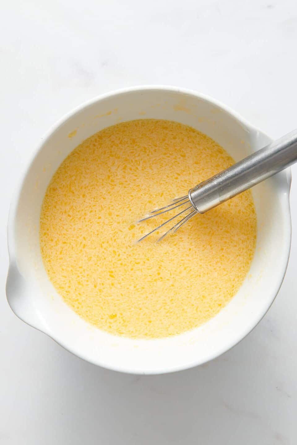 old fashioned coconut pie filling in a large white mixing bowl. 