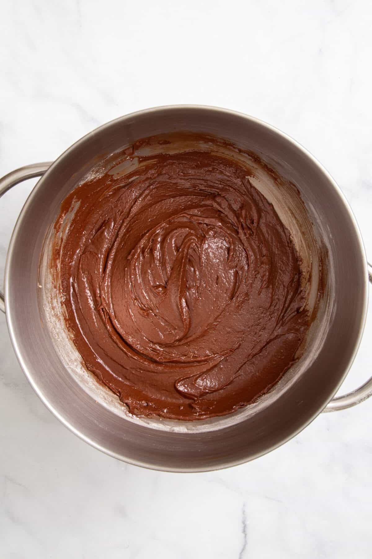 stainless steel mixing bowl with chocolate mint crinkle cookie batter. 