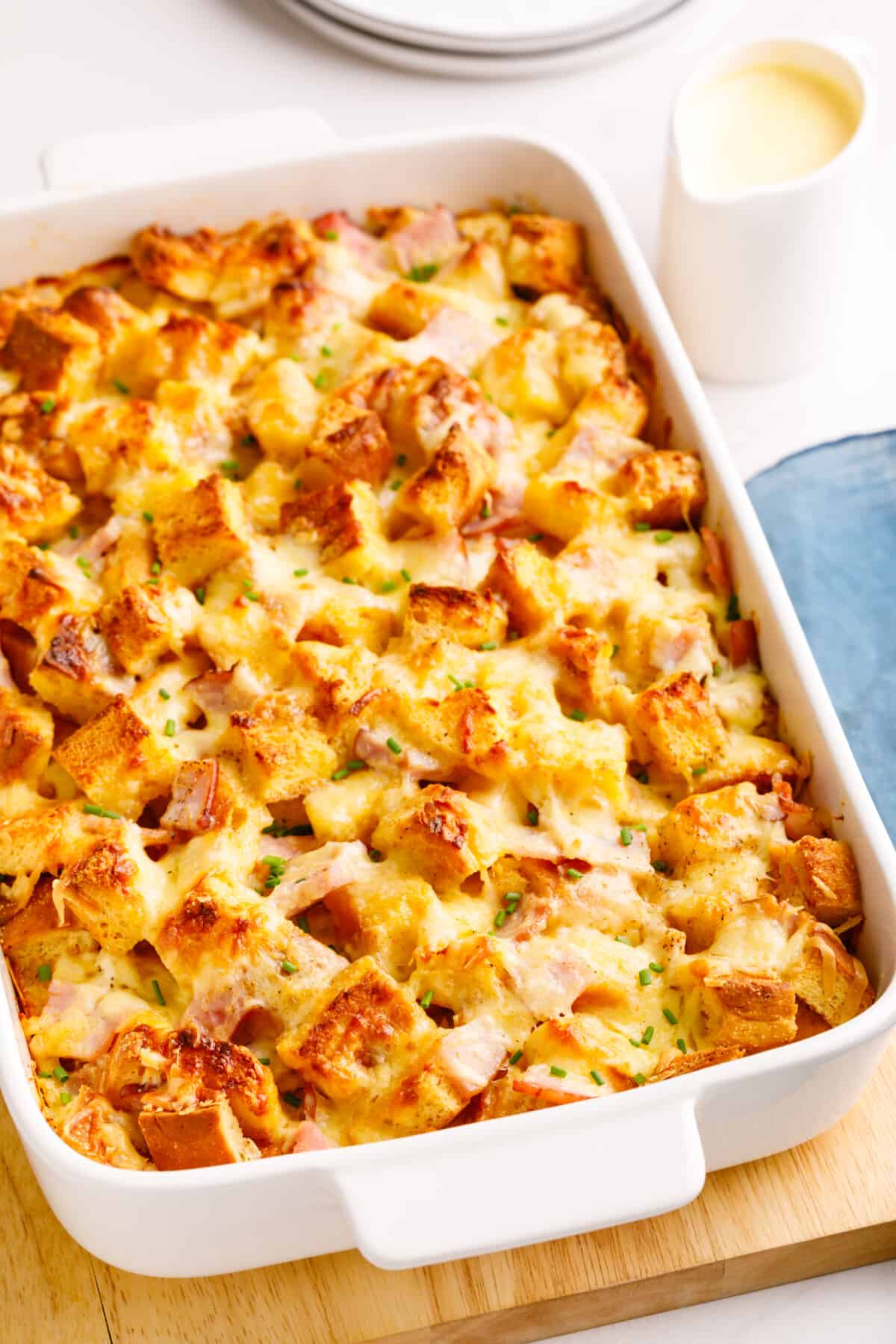 A dish of baked Eggs Benedict casserole.