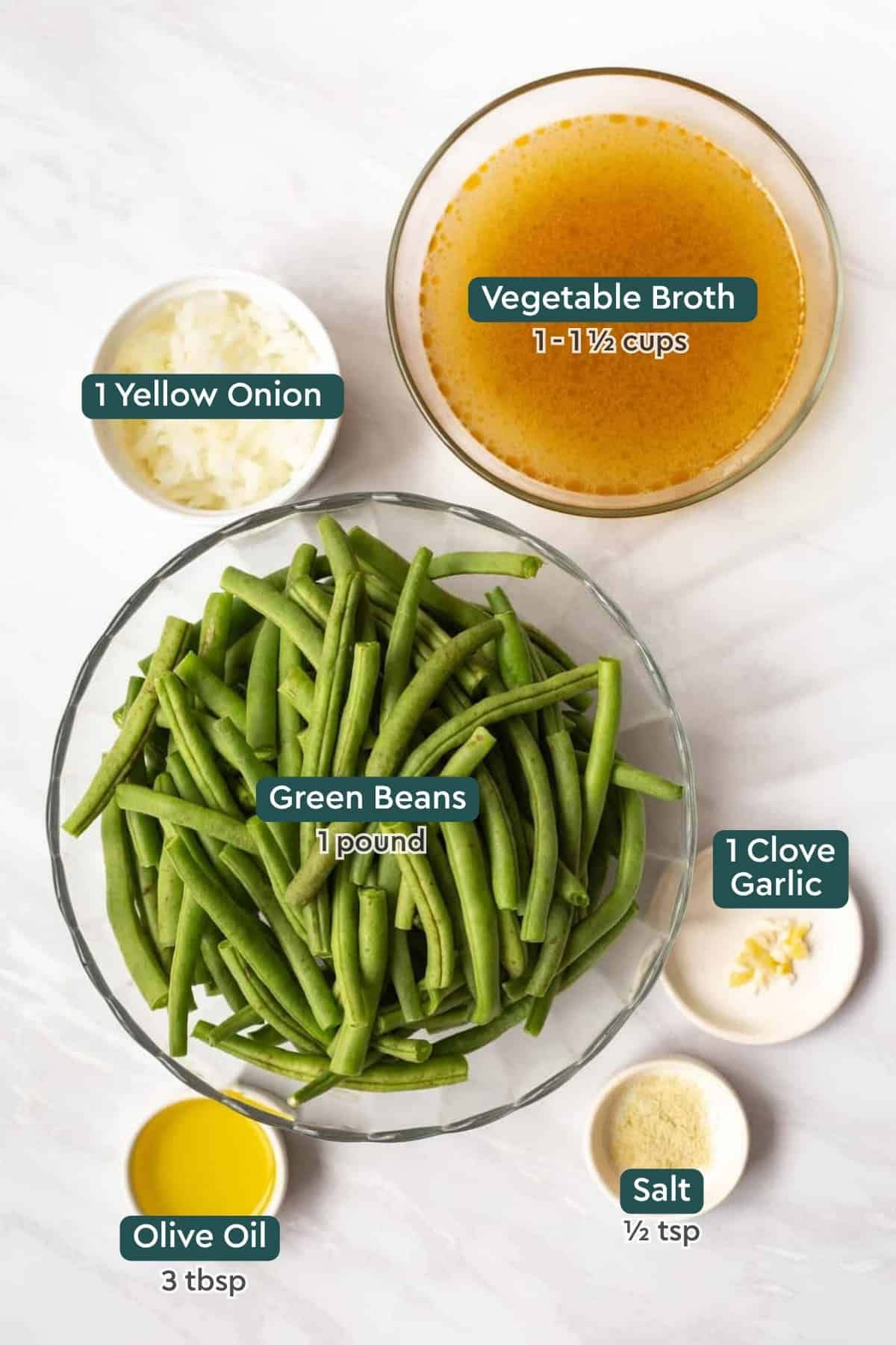 Ingredients for Instant Pot steamed green beans, including broth, onion, beans, garlic, salt, and oil.
