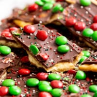 Pieces of Christmas crack topped with M&Ms and sprinkles.