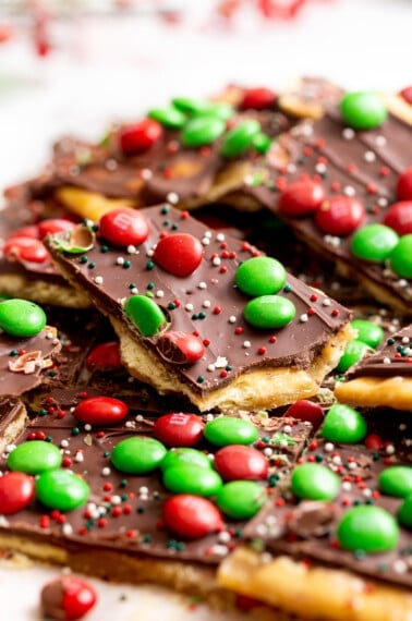 Pieces of Christmas crack topped with M&Ms and sprinkles.