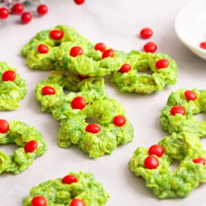Christmas wreath cookies decorated with red candies.