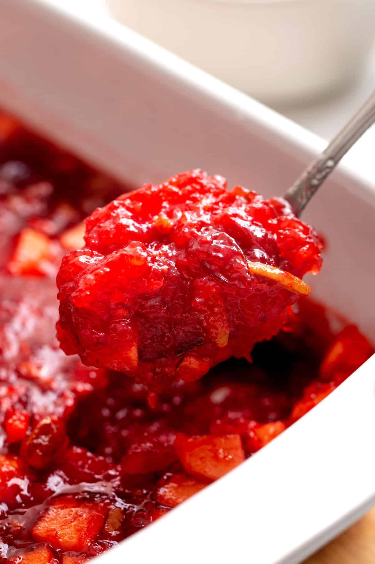 close up image of a spoonful of cranberry jello salad. 