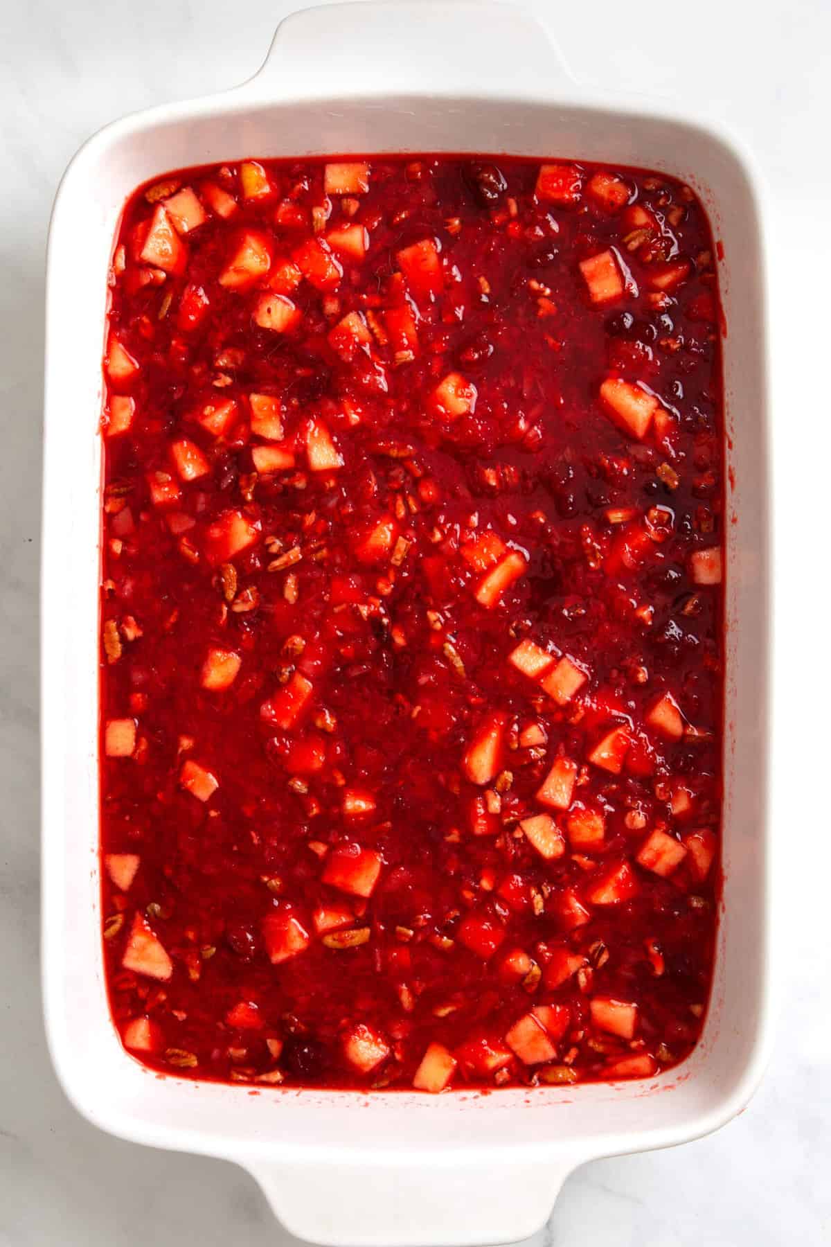 cranberry jello prepared in a 9x13 casserole dish. 